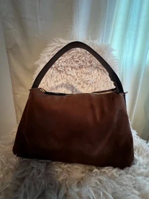 Brun mocka axelväska - Jätte fin väska i brun mocka från hm. Tyvärr kommer den inte till användning🌸