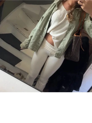 Grön overshirt från Zara - Snygg ljusgrön overshirt från Zara i kraftigt bomullstyg. Modellen har två stora fickor framtill, klassisk krage och knäppning med silverfärgade knappar. Perfekt att bära öppen över en t-shirt eller tröja för en avslappnad look.