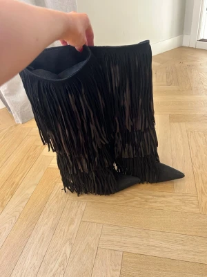 Boots - Black fringe knee high boots from Zara with a pointed toe and around 8,5 cm heel.   They are in great condition and have only been used a few hours at one occasion.   The boots are from an old Zara collection and no longer sold.  Retail price: 199EUR / 2179SEK