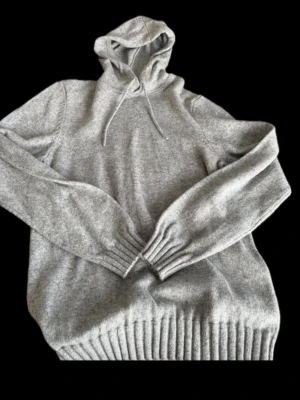 Grå stickad hoodie  - Hej, säljer nu min extremt eftertraktade och slutsålda hoodie från dressmann. Hoodien är i storlek M och passar perfekt till sommar kvällar. Skriv vid fler funderingar!