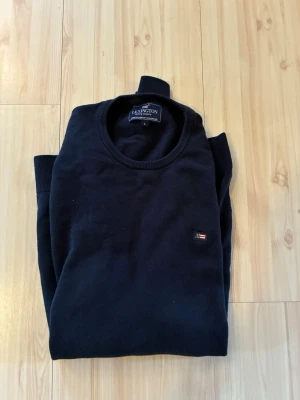 Mörkblå sweatshirt från Lexington - Klassisk mörkblå sweatshirt från Lexington med rund halsringning och diskret logga på bröstet. Tröjan har ribbade muddar vid ärmslut och nederkant. Perfekt för en stilren och enkel look.