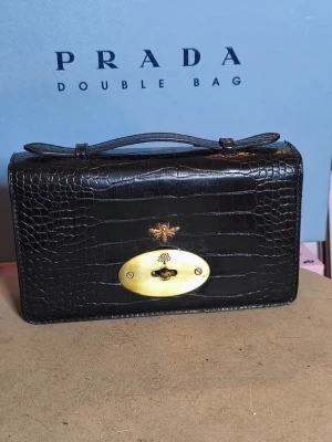🖤 Black Croc-Embossed Top Handle Bag 🖤 - Elegant, timeless, and easy to style with almost anything. This beautiful black croc-embossed bag features stunning gold-tone hardware and a structured silhouette that instantly elevates any outfit. 🤍 The spacious interior includes multiple compartments and a zippered pocket, making it practical for everyday use while still looking polished and sophisticated. It comfortably fits your phone, wallet, keys, makeup, and other daily essentials.