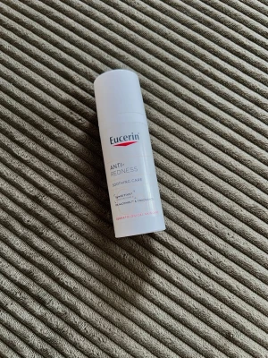 Eucerin Anti-Redness Soothing Care - Eucerin Anti-Redness Soothing Care är en vit, cylinderformad pumpflaska med 50 ml ansiktskräm. Produkten är framtagen för känslig hud och hjälper till att lugna rodnad. Fri från parfym och alkohol, dermatologiskt testad.
