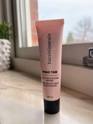 bareMinerals Prime Time Primer SPF 30 - bareMinerals Prime Time Daily Protecting Primer är en primer med SPF 30 som är framtagen för att skydda huden och ge en jämn bas inför makeup samt minskar rodnad. Tuben rymmer 30 ml. 