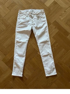 Vita skinny jeans  - Säljer ett par vita skinny jeans från Gina Tricot. De har klassisk femficksmodell, hög midja och smal passform hela vägen ner. Perfekta att matcha med en crop top eller hoodie för en clean look. Materialet är stretchigt för extra komfort.