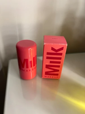Milk Makeup jelly Rouge Stick - Milk Makeup jelly tint i färgen Chill är ett cooling jelly tint i en smidig stickform. Förpackningen är cylinderformad och har en stark rosa färg med tydlig logga. Produkten ger en fräsch, naturlig look. Inte använd alls mycket endast nån enstaka gång.