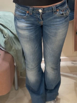 True Religion bootcut jeans blå - säljer ett par jättefina jeans från true religion, de är ganska trasiga på ena hälen men man tänker inte på de så mycket! har även sytt upp de lite i längden men de är jätte enkelt att sprätta bort då de bara är några få stygn som ni ser på sista bilden! just denna färg är dyrare än vissa andra, därför priset💗kan tänka mig gå ner i pris!