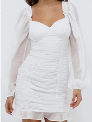 Studentklänning med ballongärm - Superfin vit kort klänning med transparenta puffärmar och rynkade detaljer. Klänningen har en volangkant nertill. Inte genomskinlig!