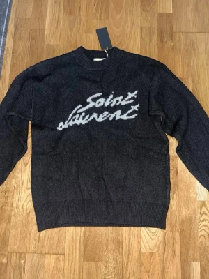 Svart Saint Laurent stickad tröja - Hej! Säljer min stickade Saint Laurent tröja då den är alldeles för stor för mig, den är autentisk och helt ny (Storlek M)! Lappar och allt följer med men även en påse från Saint Laurent! Har du några frågor eller undrar över något så är det bara till att skicka ett dm! //Oscar