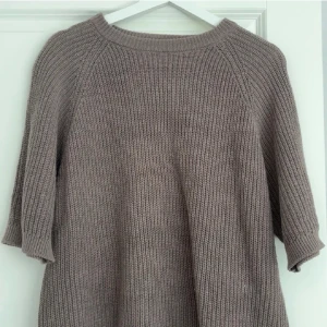 Brun stickad tröja från 157 - Säljer en Brun stickad tröja från 157 i storlek XS. Tröjan har en avslappnad passform, rund halsringning och halvlånga ärmar. Perfekt för lager på lager och enkel att matcha med olika outfits.