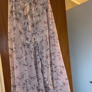 Puderrosa kjol  - Superfin och romantisk, lite genomskinlig blommig kjol från Gina Tricot. Det är shorts under och knytning i midjan fram och dragkedja bak. 