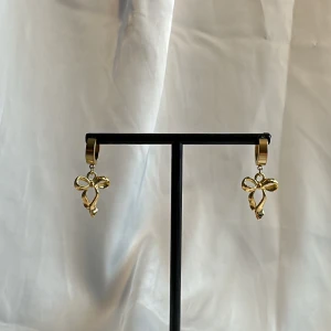 Guldiga örhängen - Egentillverkade guldiga örhängen med guldiga berlocker i form av hjärtan