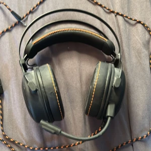 Spel hörlurar  - Jag säljer ett par svarta spel hörlurar med en cool eld effekt där örat är! Kom gärna med prisförslag!