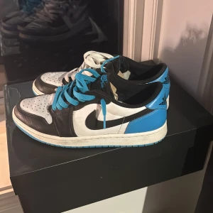 Nike Air Jordans i svart, vit och blå - Snygga Nike Air Jordans med en fräsch färgkombination av svart, vit och blå. Skorna har en klassisk design med snörning och en ikonisk logga på hälen. Perfekta för dig som vill ha en stilren look. Digitalt ocg fysiskt kvitto finns.
