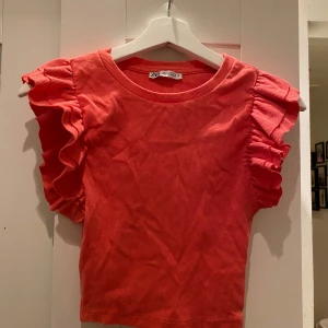 Korallfärgad topp från Zara - Jättesnygg volangtopp från Zara. Mycket mer rosa/korallig än på bilden. Använd men i mycket bra skick. 💗