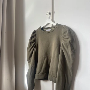 Olivgrön tröja med puffärmar - Säljer en olivgrön tröja från Only med puffiga långa ärmar. Tröjan har en rund halsringning och är perfekt för en stilren look. Passar bra till både jeans och kjol. Perfekt för höst och vår! Pris kan diskuteras💘
