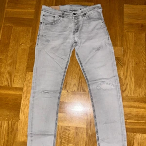 Gråa Mius dondup jeans - Gråa Dondup jeans i modellen Mius. Storleken är 33w men passar också 32w. Jeansen har också ganska många slitningar. Kontakta gärna mig om du har några funderingar eller vill ha fler bilder.