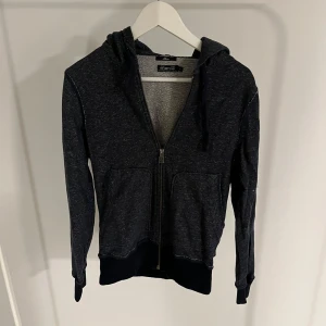 Mörkgrå hoodie med dragkedja - En fet hoodie från energie, perfekt om man vill ha som basplagg och har en fet vintage look!