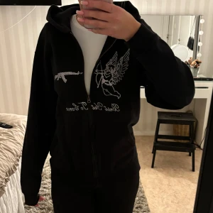 Svart hoodie med strassdetaljer - Hej! Säljer denhär zip hoodien från Best yet to Come då den längre kommer till användning💗tröjan är i jättebra skick och har inga märken! Snöre till hoodien finns med men sitter inte i på bilderna💕pris kan diskuteras!