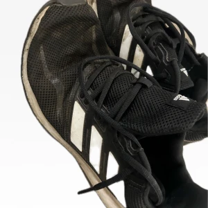 Adidas Running shoes Black size 44 - Adidas running shoes in black. The shoes are in used condition and have visible signs of wear.