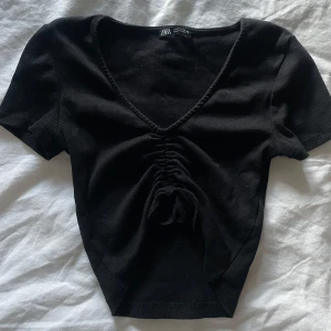 Svart topp - Jättegullig svart ribbad topp från Zara i strl S. Använd väldigt få gånger så nästan som ny! Pris är diskuterbart vid snabbt köp!