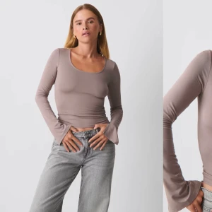 Beige långärmad topp - Snygg beige långärmad topp med en tight passform. Perfekt för både vardag och fest. Den har en enkel design med rund hals och är tillverkad i ett mjukt material som känns skönt mot huden.
