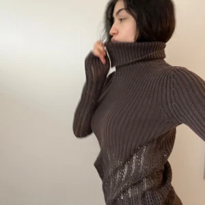 Brun ribbad polotröja - Säljer en snygg brun ribbad polotröja med lång ärm. Den har en cool, genombruten design som ger en unik look. Perfekt för höst och vinter, och den är både varm och stilren. Passar bra till jeans eller kjol för en avslappnad men chic stil.