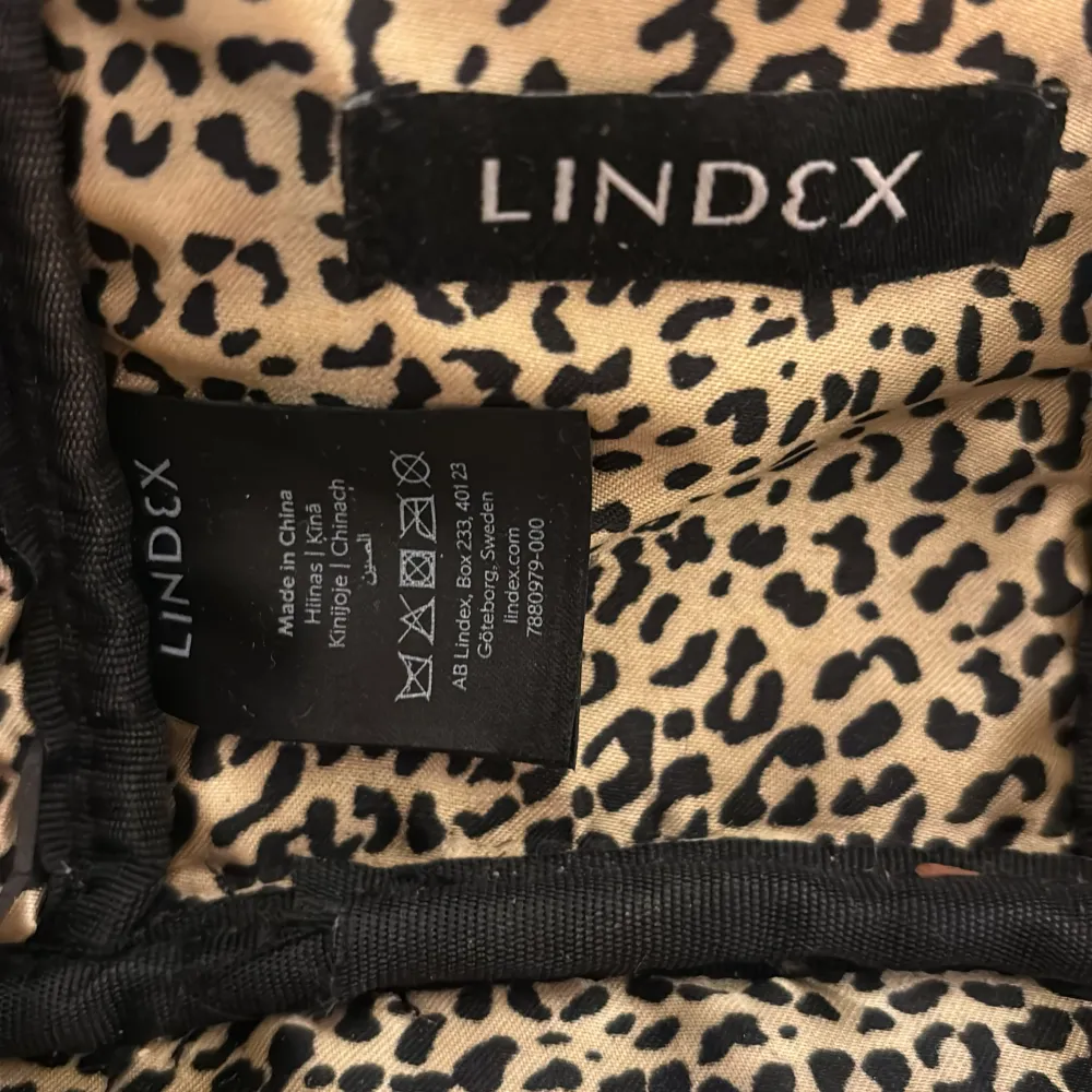 Säljer en stilren svart necessär från Lindex i syntetmaterial. Den har en praktisk dragkedja och ett coolt leopardmönstrat foder. Perfekt för att hålla ordning på dina saker när du reser eller bara hemma. 💕. Väskor.