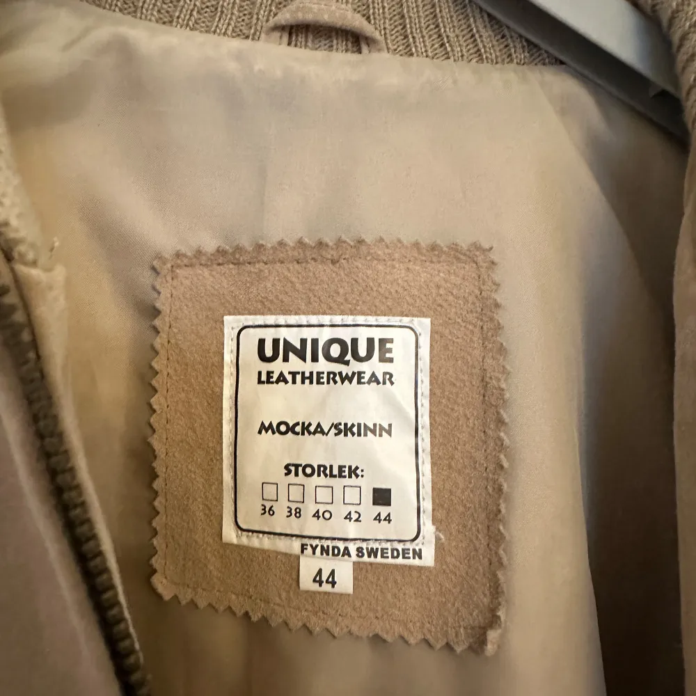 Säljer en snygg beige mockajacka från Unique Leatherwear i storlek 44. Jackan har långa stickade ärmar och ribbade muddar. Perfekt för höst och vår med sin stilrena design och dragkedja framtill. Passar både till vardags och lite finare tillfällen.. Jackor.