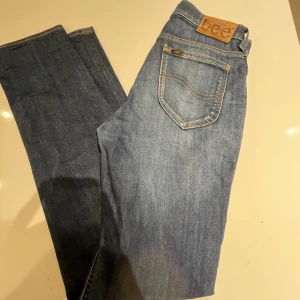Blå jeans från Lee - Säljer ett par klassiska blå jeans från Lee i modellen Rider. De har en snygg, normal passform och är tillverkade i slitstarkt denim. Perfekta för både vardag och fest! 🕺