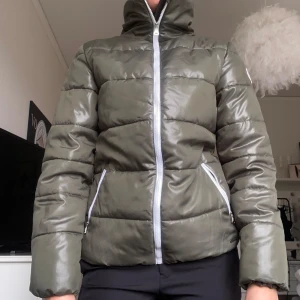 Jacka - Snygg militärgrön/olivfärgad skidjacka ifrån onthepeak. Glansig i materialet. 