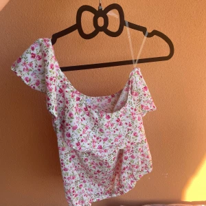 Blommig topp  - Blommig söt sommartopp från new yorkers märke sisters❤️  Den är ärmlös på ena sidan! 