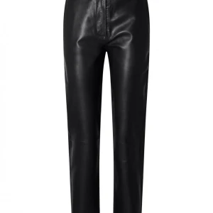 Svarta skinnbyxor - Skinnbyxan Marie från Selected Femme. En snygg svart byxa i skinn. Designad med raka ben och skuren längd. Fickor fram och passpoal fickor bak. Dragkedja och dold förslutning fram för att stänga byxan. Styla med en skjorta till ett par sneakers för en snygg vardags look eller styla till en blus och ett par sandaletter för en mer festlig look! Helt enkelt den perfekta skinnbyxan som går att använda till mycket! Plaggmått tagna på storlek 34 Innerbenslängd: 73 cm Midjemått: 68 cm 