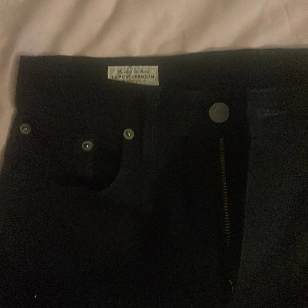 Säljer ett par svarta jeans i storlek W30 L32. De är i bra skick och har en klassisk design med fem fickor och knappgylf. Perfekta för både vardag och fest!. Farkut & Housut.