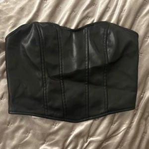 Korsett festtopp i läderimitation  - Jättefin festtopp, korsettliknande modell i läderimitation  Helt oanvänd
