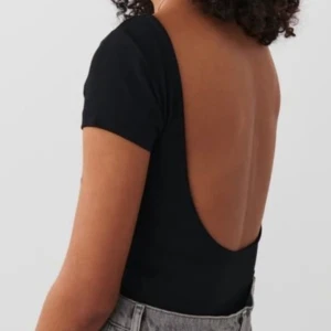 Svart topp med öppen rygg - Köpt från Gina, aldrig använd. Storlek S i super skönt material. Skicka ett meddelande för fler bilder