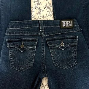 True Religion jeans - Så otroligt snygga unika lågmidjade True Religion jeans med paljetter på märket och snygga fickor bak som tyvärr säljs, dem är bootcut, storlek W28 så passar XS/S, dem är från 2000-talet men är i väldigt bra skick