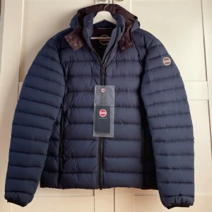 Colmar Jacka - Snygg mörkblå dunjacka från Colmar med dragkedja och huva. Helt ny, aldrig använd! Säljs pga att den är för liten för mig. Perfekt för kyliga dagar. Storlek 48, motsvarar S. Tags fortfarande kvar💯 Pris kan diskuteras vid snabb affär!