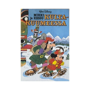 Mikki ja Hessu Kulta-Kuummeessa - En serietidning med Mikki och Hessu på äventyr i snölandskap. Omslaget visar dem i vinterkläder med snöskor, omgivna av berg och totempålar. Perfekt för Disney-fans och serietidningssamlare.