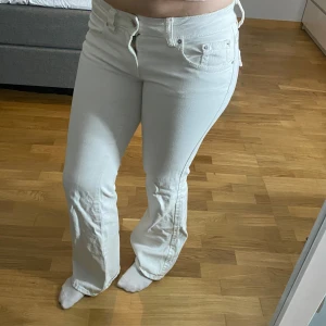 Vita jeans från Gina Tricot - Snygga vita jeans från Gina Tricot med bootcut-stil. Fickor på baksidan och låg midja. Dom har en fläck på höger ben därav priset🩷