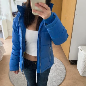 Blå puffer jacket - Blå puffer jacket som håller värmen väldigt bra. Har dragkedja, fickor med dragkedja och luva. Pris kan diskuteras! Fråga för fler bilder så fixar jag det.