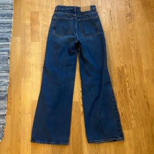 Blå jeans med hög midja - Säljer ett par snygga blå jeans med hög midja. De har en klassisk femficksdesign och en bekväm passform. Perfekta för både vardag och fest!