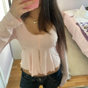 Rosa topp Gina Tricot  - Söt rosa långärmad topp från Gina tricot med spetsdetaljer och en liten rosett framtill. Strl M passar mig som brukar ha S, ge prisförslag!