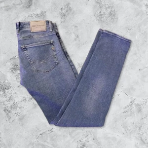 Blå jeans från Replay - Snygga blå jeans från Replay med klassisk femficksdesign och knappgylf. Perfekta för en avslappnad stil. Byxorna är bra skick och använda fåtal gånger.