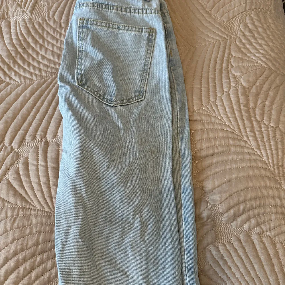 Snygga ljusblå jeans med fransar vid bensluten. De har en klassisk femficksdesign och en avslappnad passform. Perfekta för en casual look.. Farkut & Housut.