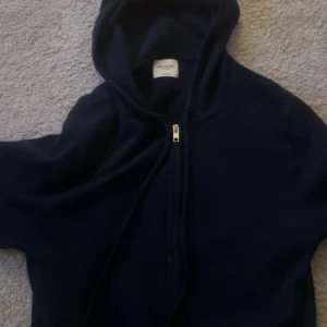 Mörkblå hoodie med dragkedja - Hej! Säljer en mörkblå zip hoodie från John Henric i storlek S. Tröjan är i gott skick, men har däremot små hål vid armbågarna. Hör av er vid frågor.
