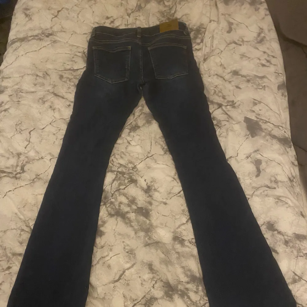 Ett par skitsnygga mörkblå lågmidjade jeans från Nelly. Slitningar där nere:) . Jeans & Byxor.