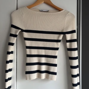 Randig ribbad tröja från Zara - Säljer en snygg ribbad tröja från Zara i beige och svart. Den är helt oanvänd!