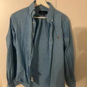 Blå skjorta från Ralph Lauren - säljer nu denna tvär snygga ralph lauren skjortan. storlek S och är slimfit. skicker avgör du själv utifrån bilderna men enligt mig är den i topp skick