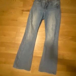 Blå bootcut jeans - Snygga blå bootcut jeans med en klassisk look. Perfekta för en avslappnad stil. De har en hög midja och en lätt utsvängd passform som ger en retro känsla.